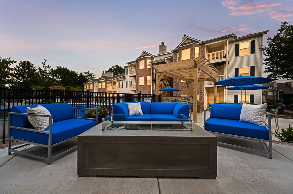 Birmingham, AL apartment complex poolside fire pit and lounge with lounge chairs at Chace Lake Villas